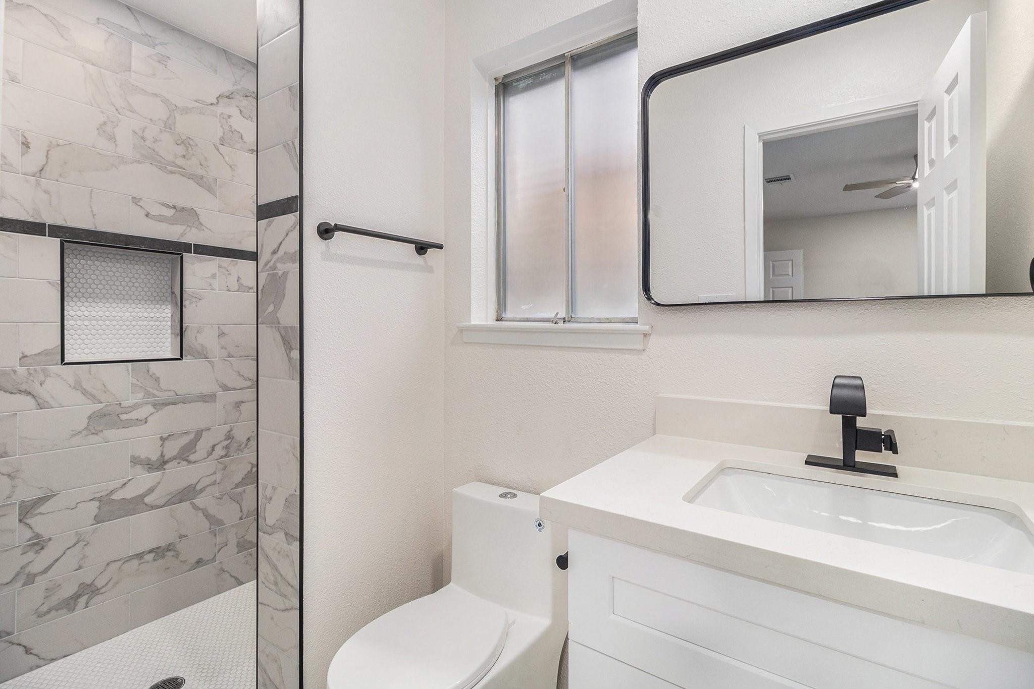 1510 Tarberry Road Houston, TX 77088 - Photo 12 of 19 a bathroom with a sink a toilet and mirror