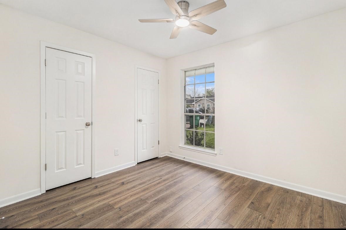1510 Tarberry Road Houston, TX 77088 - Photo 13 of 19 a view of an empty room with wooden floor and a window