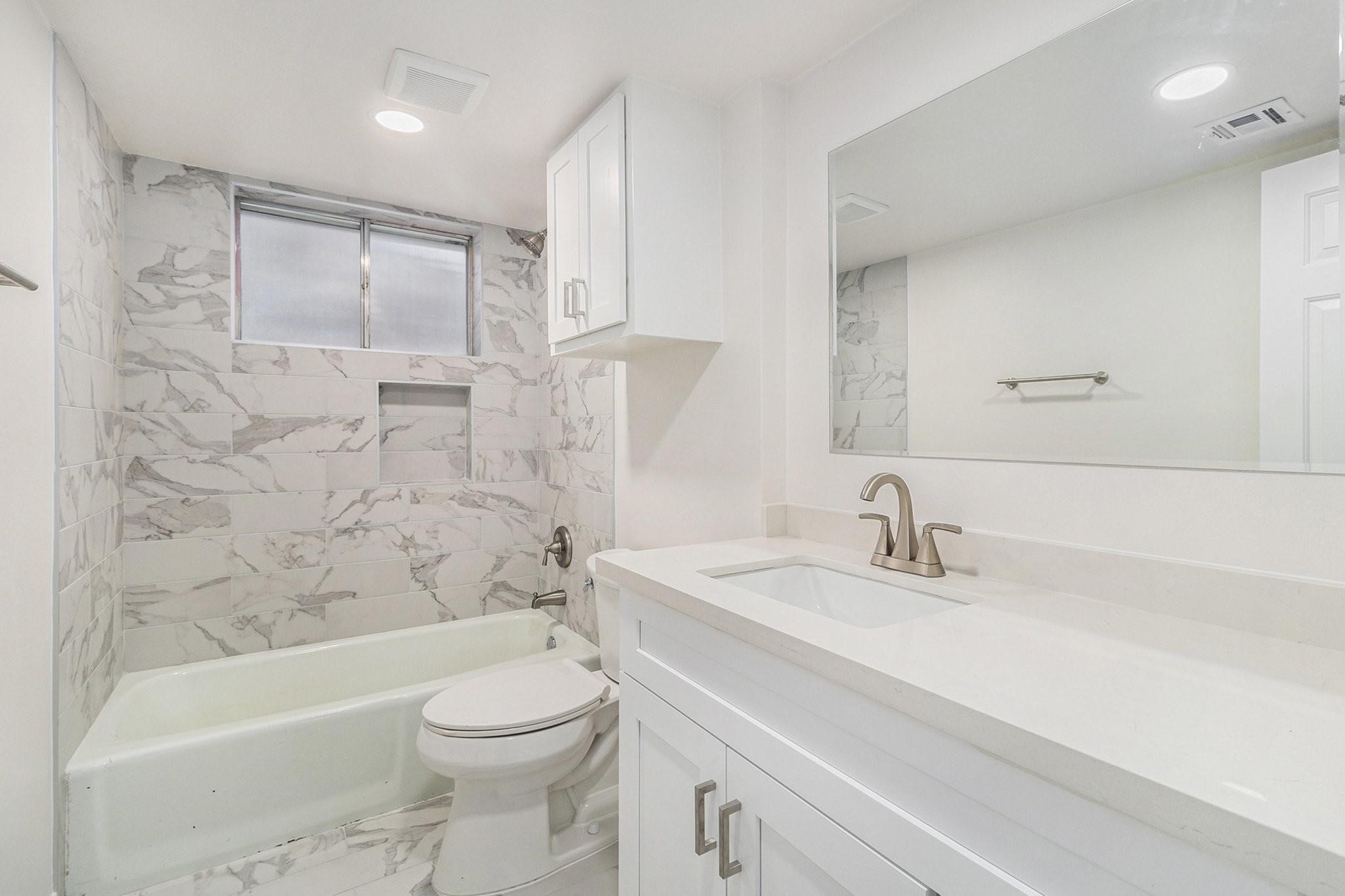 1510 Tarberry Road Houston, TX 77088 - Photo 14 of 19 a bathroom with a sink a toilet and a bathtub