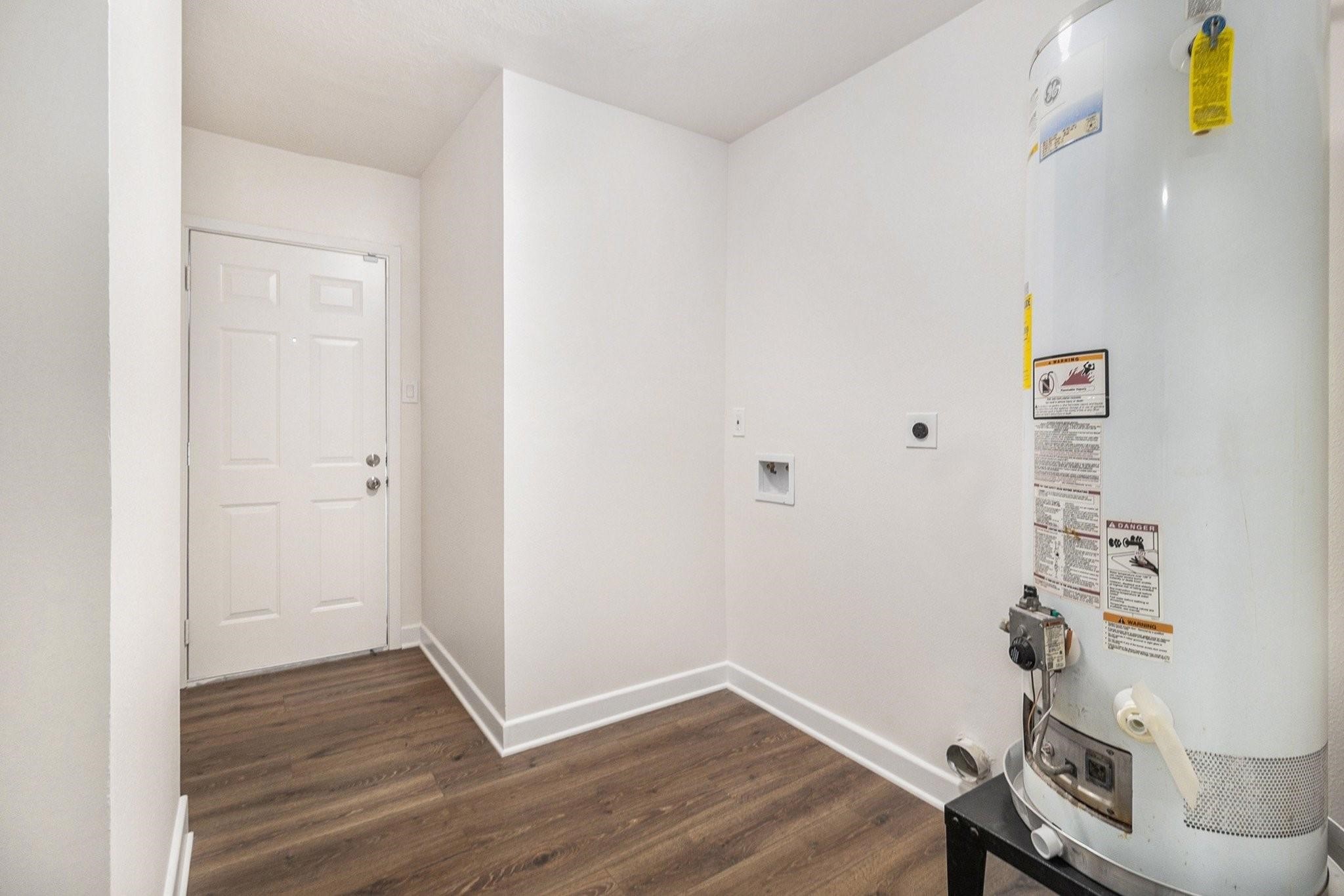 1510 Tarberry Road Houston, TX 77088 - Photo 16 of 19 a view of storage and utility room with wooden floor