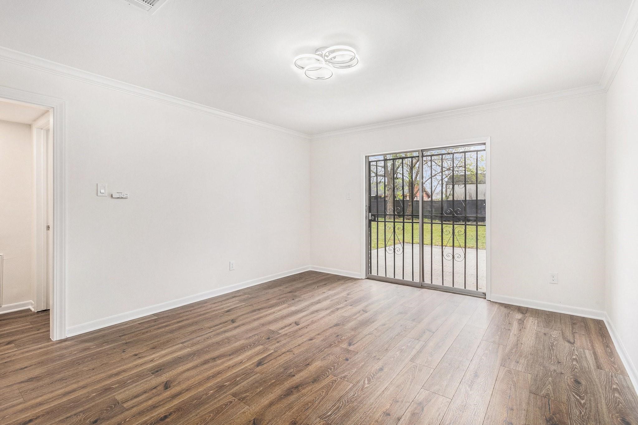 1510 Tarberry Road Houston, TX 77088 - Photo 7 of 19 a view of an empty room with wooden floor and a window