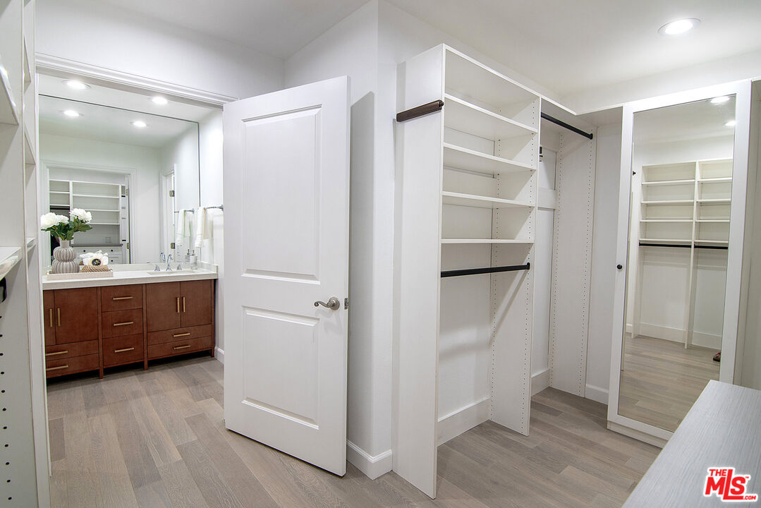 1887 Greenfield Avenue, Unit 110 Los Angeles, CA 90025 - Photo 11 of 18 a room with a closet and a walk in closet