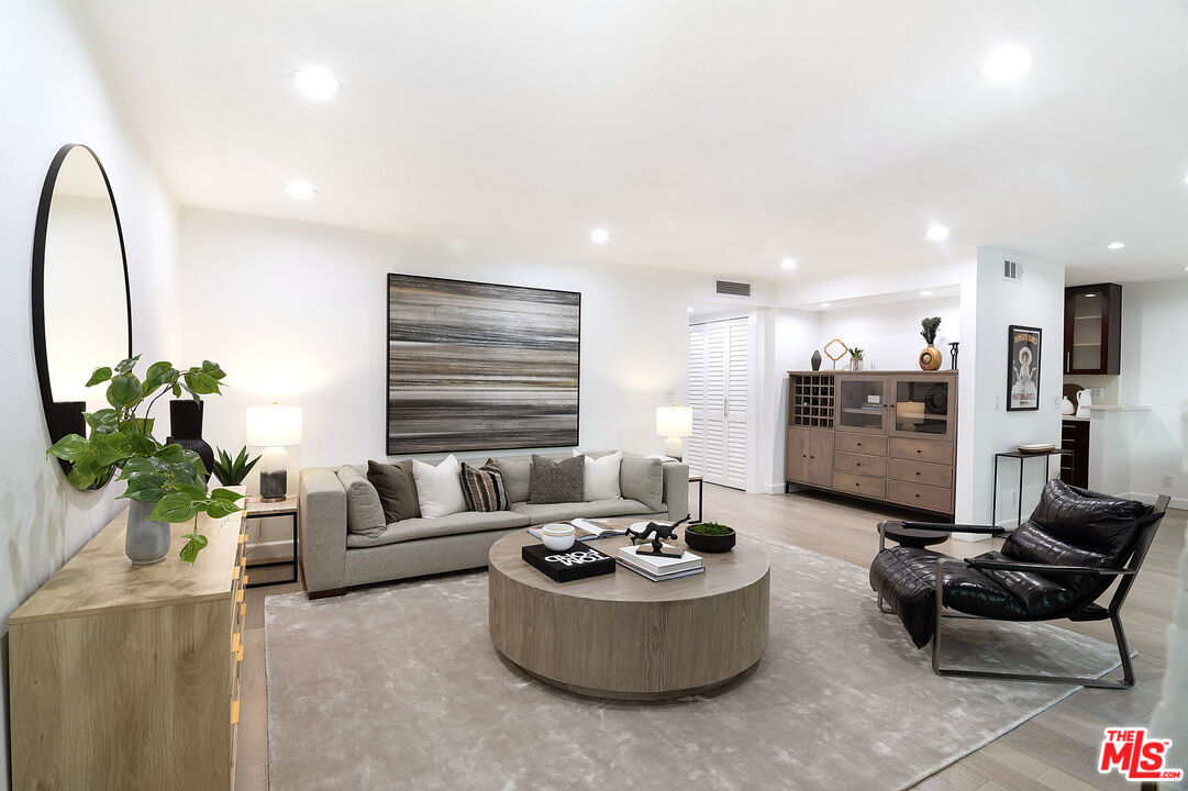 1887 Greenfield Avenue, Unit 110 Los Angeles, CA 90025 - Photo 2 of 18 a living room with furniture and a large window
