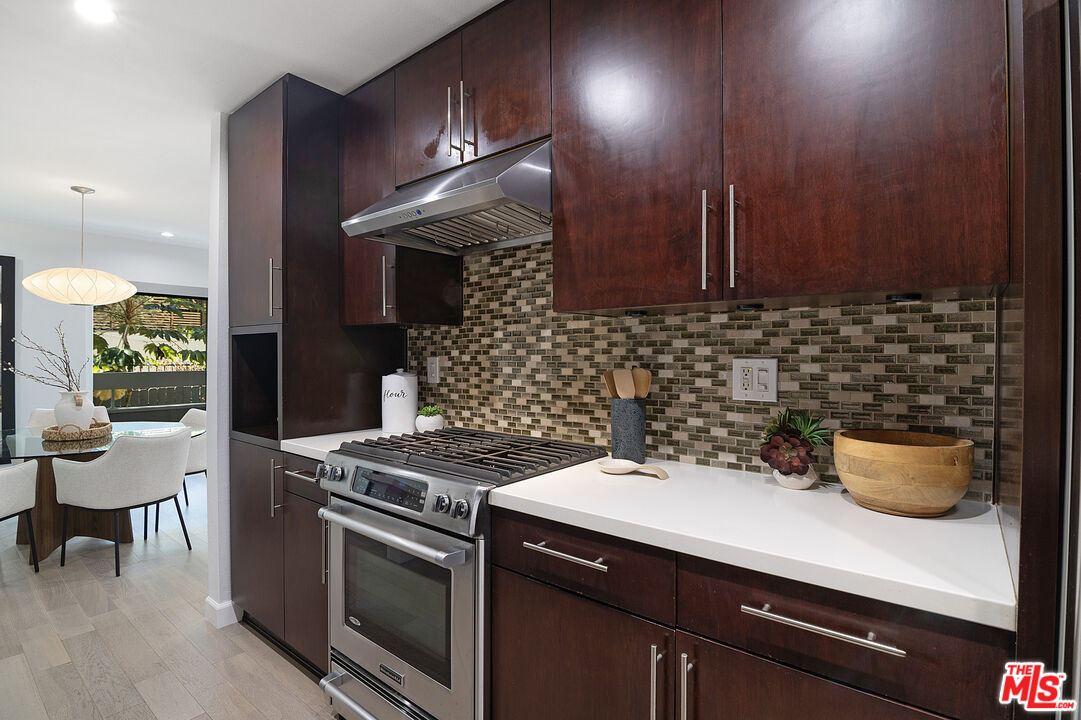 1887 Greenfield Avenue, Unit 110 Los Angeles, CA 90025 - Photo 8 of 18 a kitchen with a sink and a stove top oven