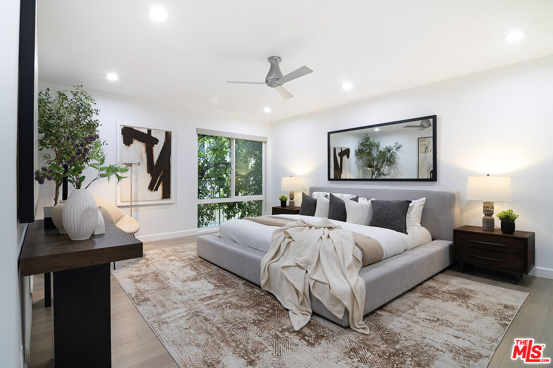 1887 Greenfield Avenue, Unit 110 Los Angeles, CA 90025 - Photo 9 of 18 a bedroom with a large bed and a window