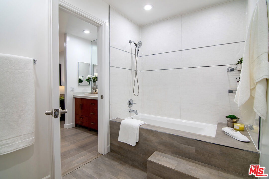 1887 Greenfield Avenue, Unit 110 Los Angeles, CA 90025 - Photo 10 of 18 a bathroom with a tub a sink and a shower