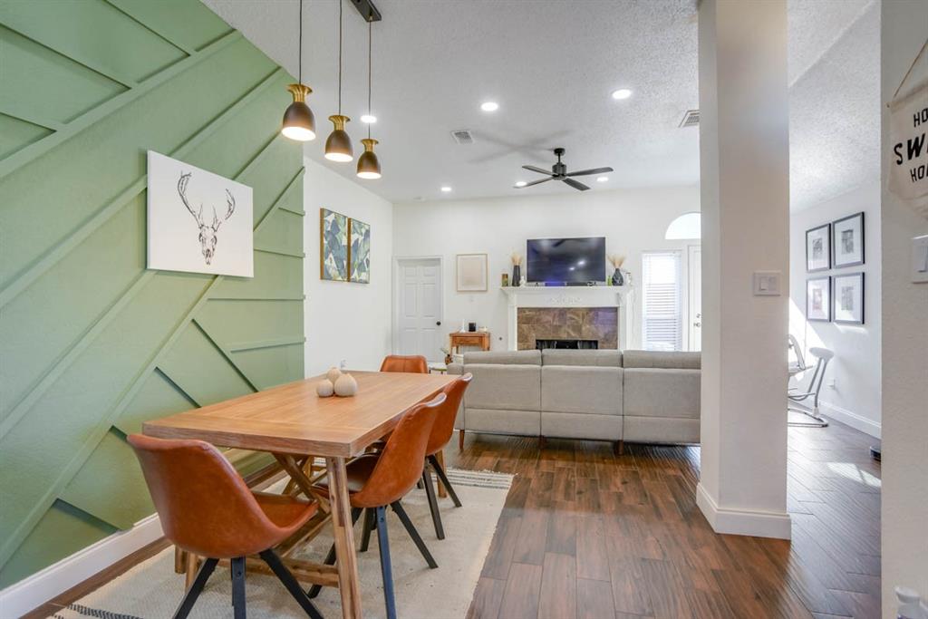 a view of a dining room with furniture and wooden floor