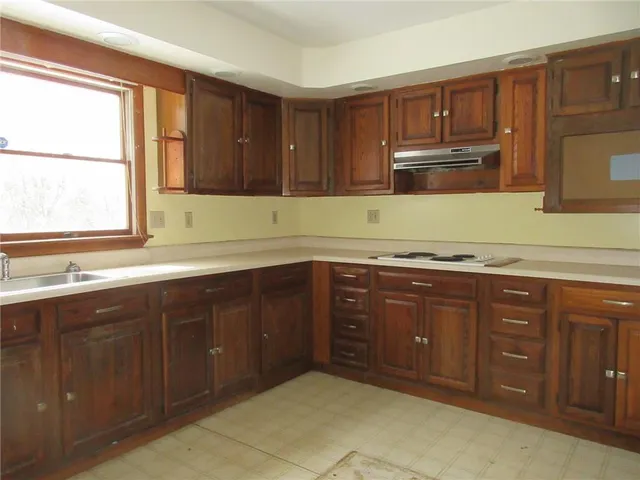a kitchen with sink and cabinets