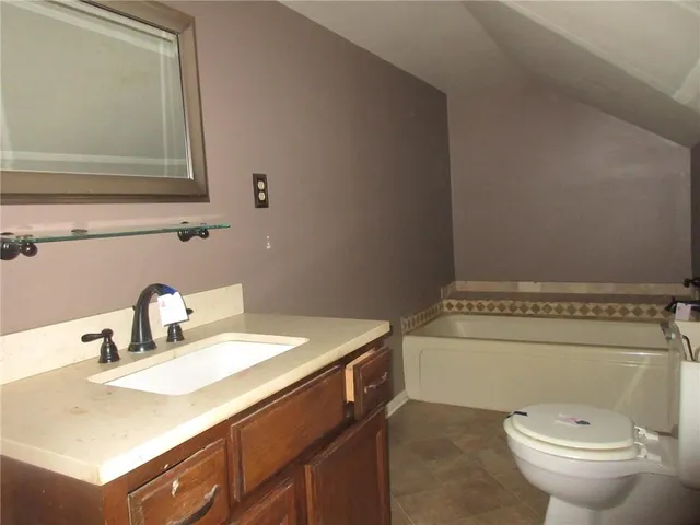 a bathroom with a sink toilet and a mirror