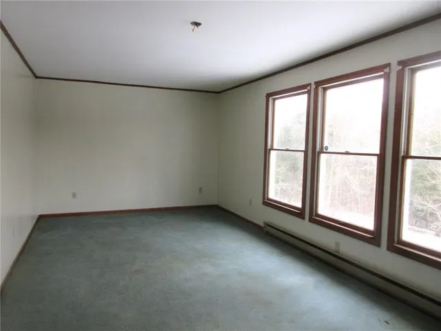 an empty room with a empty space and windows