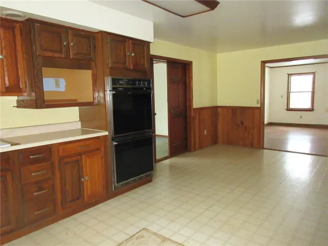a kitchen with stainless steel appliances a refrigerator and wooden cabinets