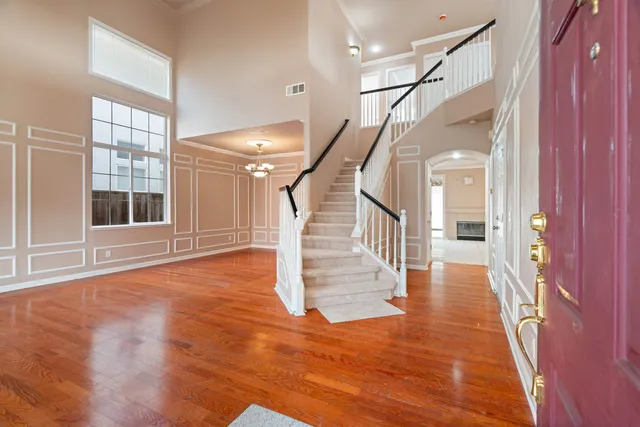a view of entryway and hall with wooden floor