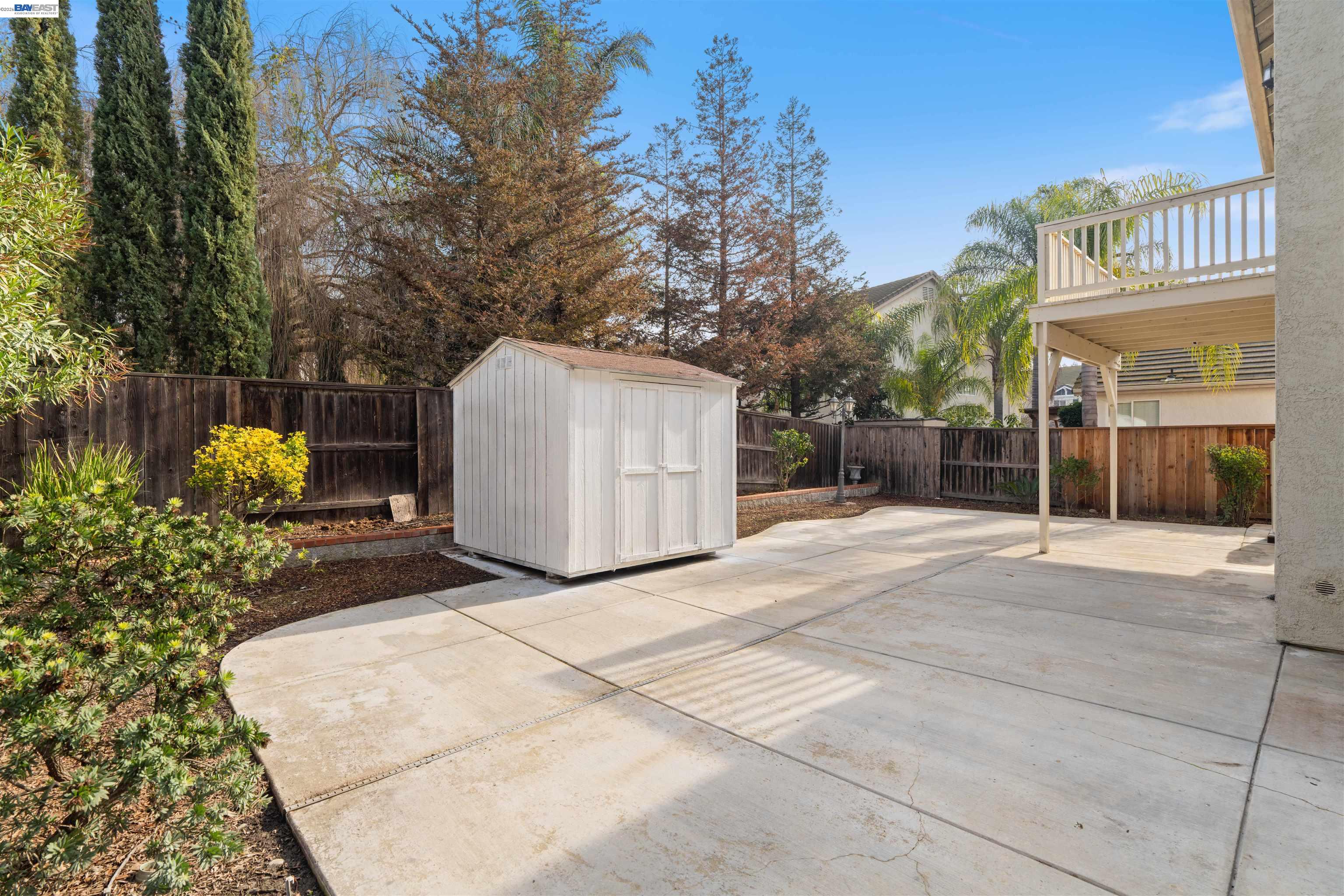 4925 Bay View Circle Stockton, CA 95219 - Photo 36 of 47 a view of a white house with a yard and a large tree