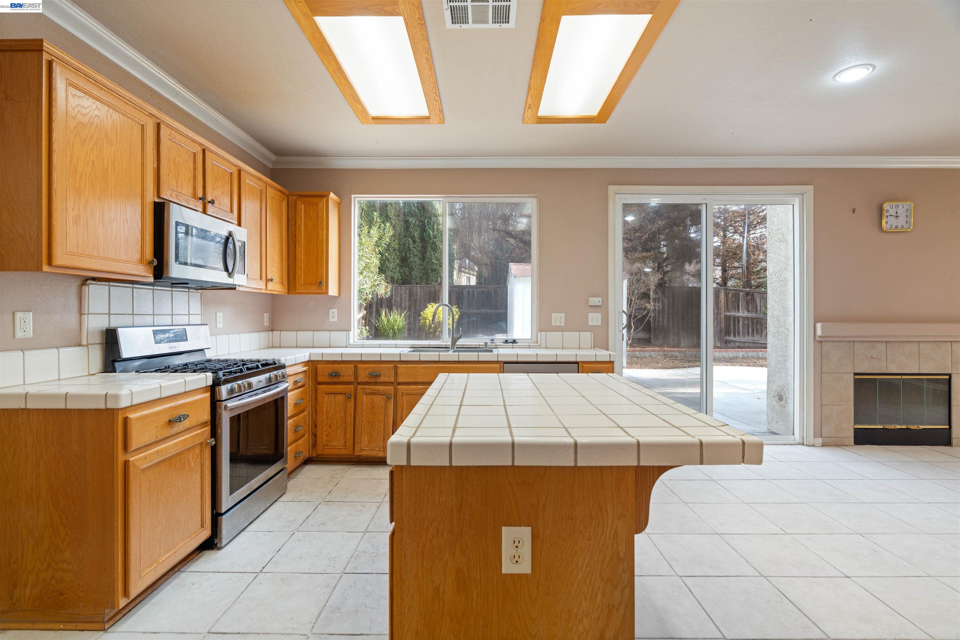 4925 Bay View Circle Stockton, CA 95219 - Photo 6 of 47 a kitchen with stainless steel appliances granite countertop a stove a sink and a microwave