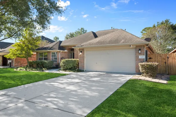 a front view of a house with a garden and yard