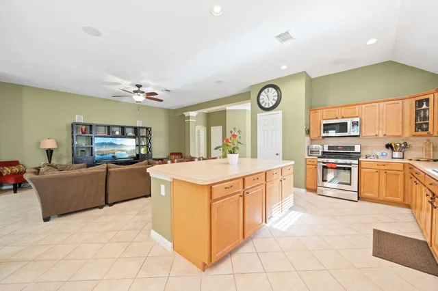 a kitchen with stainless steel appliances granite countertop a stove and a sink