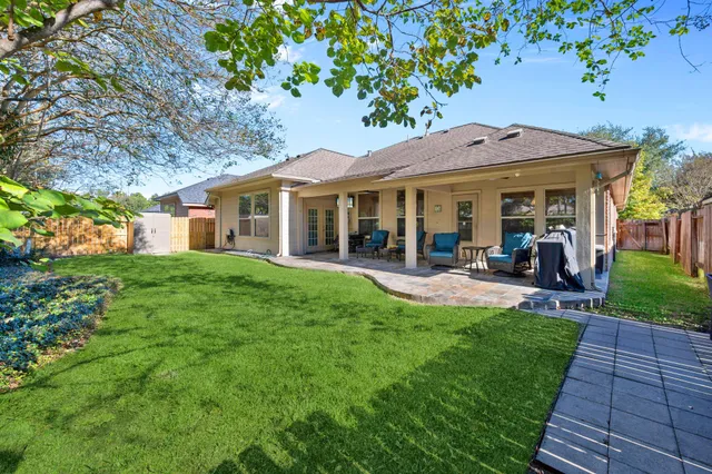 a view of a house with a yard porch and sitting area