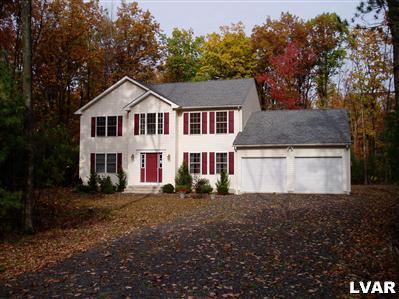 1 Long Mt Road Effort, PA 18330 - Photo 1 of 6 a front view of a house with a yard and garage