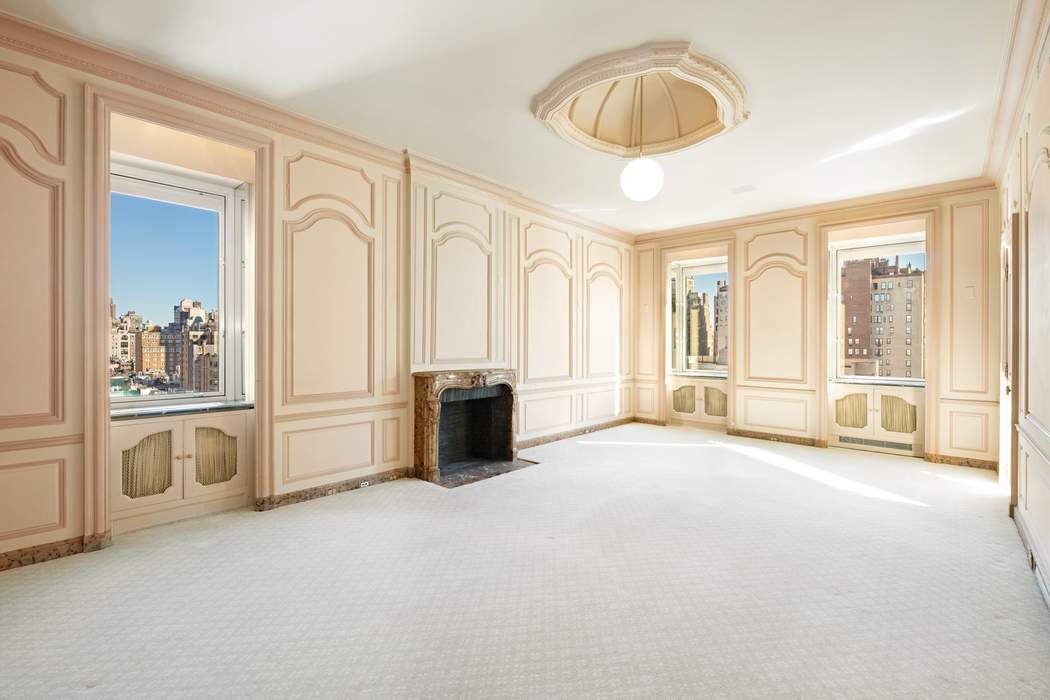 910 5th Avenue, Unit 11BC Manhattan, NY 10021 - Photo 13 of 18 an empty room with chandelier fan and windows