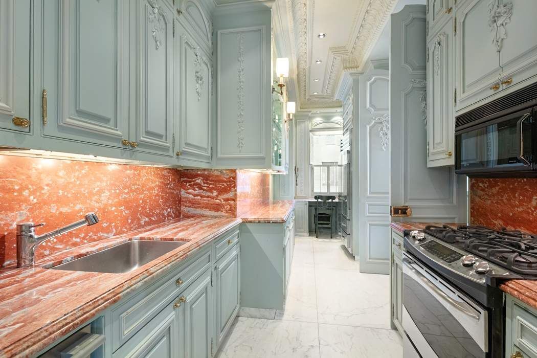 910 5th Avenue, Unit 11BC Manhattan, NY 10021 - Photo 16 of 18 a kitchen with stainless steel appliances granite countertop a sink and a stove