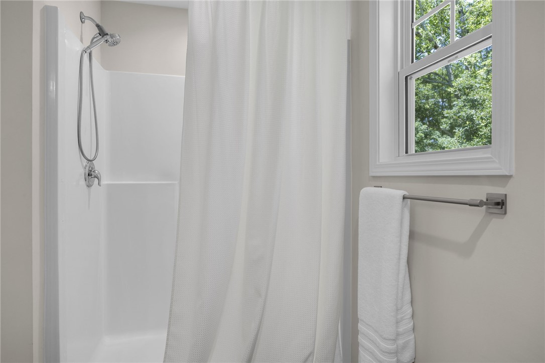 430 Johnson Road Central, SC 29630 - Photo 16 of 36 A well-appointed shower stall features contemporary fixtures and ample light from a nearby window.