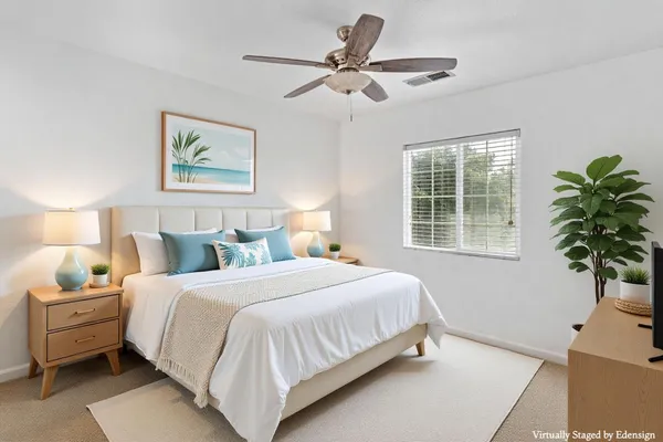 a bathroom with a granite countertop double vanity sink mirror and toilet
