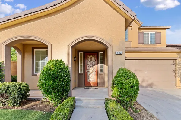a kitchen with stainless steel appliances kitchen island granite countertop a sink a refrigerator and a stove