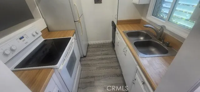 a house with wooden floor washer and dryer