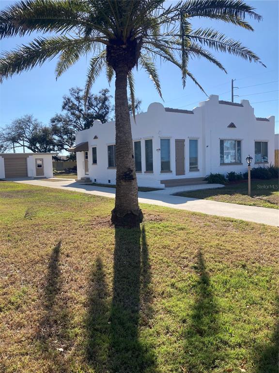 a swimming pool with outdoor seating and yard