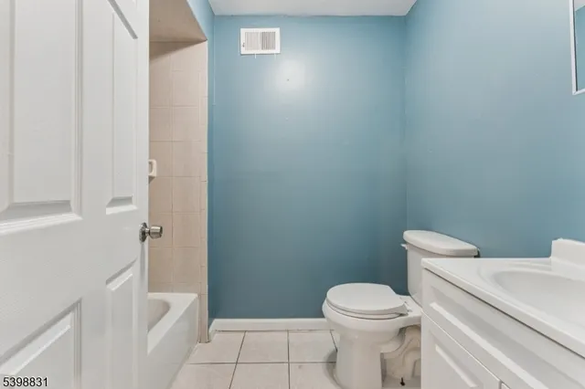 a white toilet sitting next to a bathroom sink