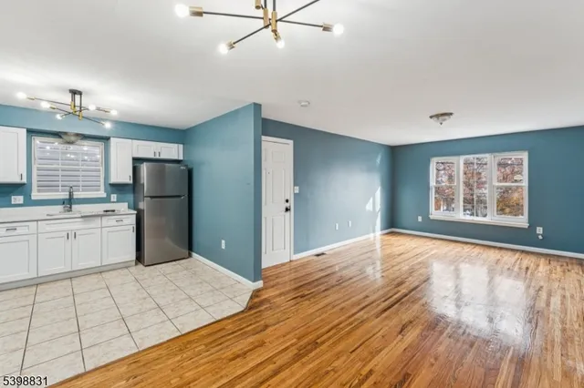 a large white kitchen with cabinets