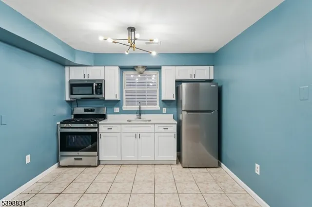 a kitchen with a stove top oven and cabinets