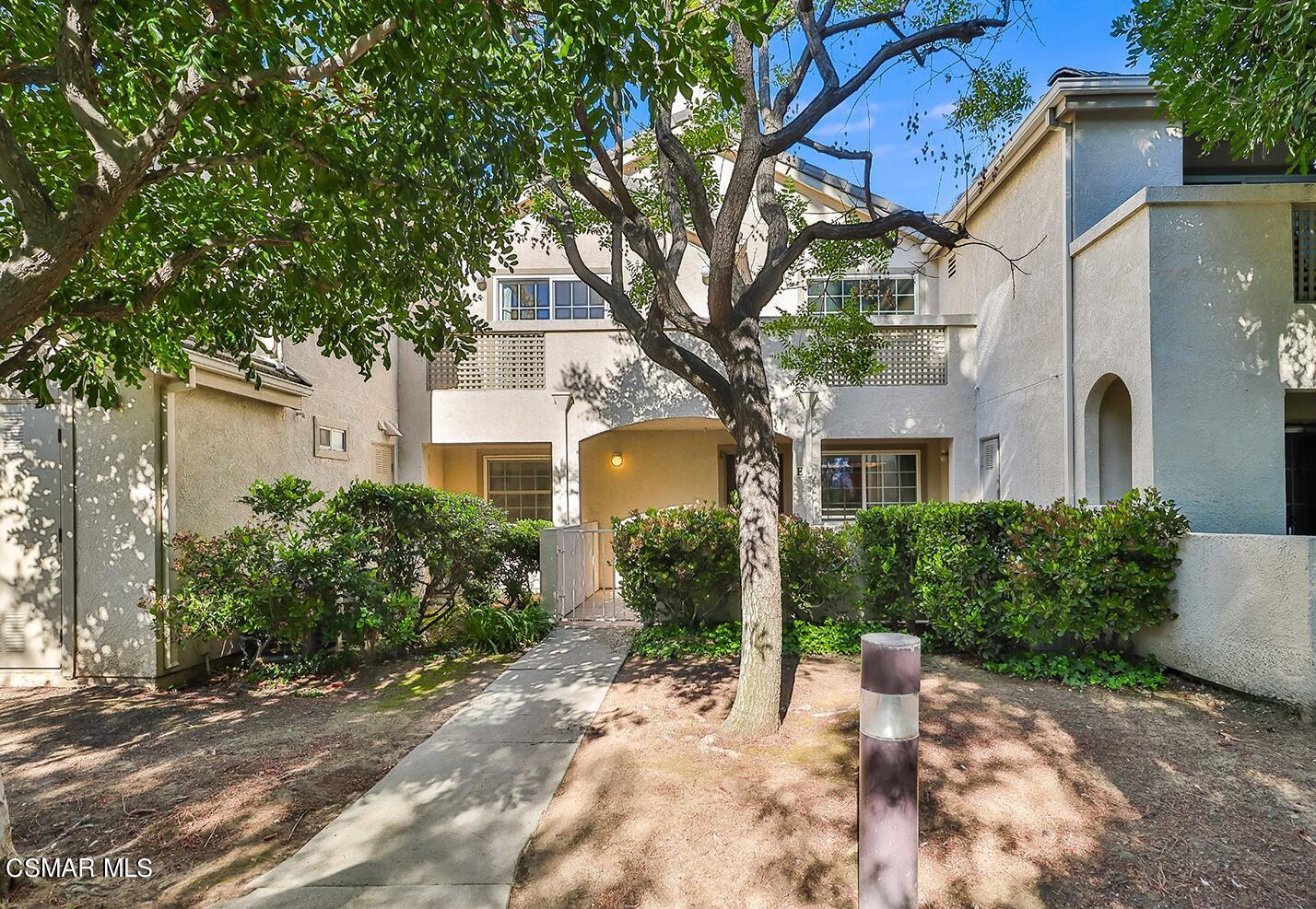 1195 Fitzgerald Road, Unit E Simi Valley, CA 93065 - Photo 1 of 19 a front view of a house with garden