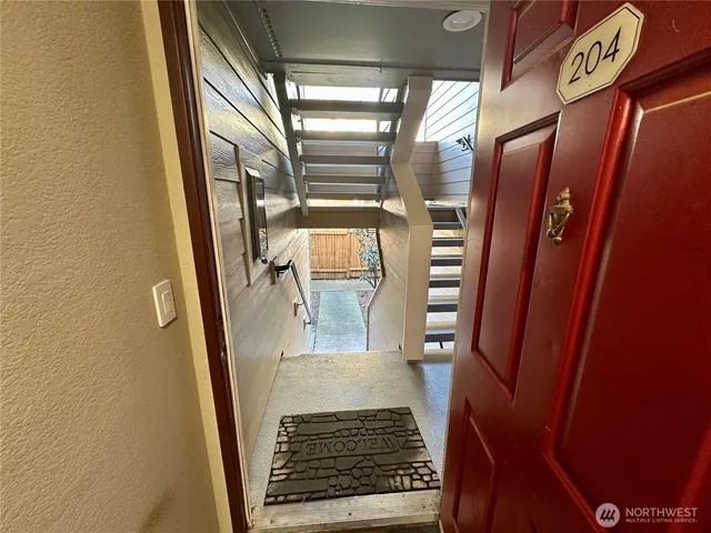 an empty room with windows and fireplace