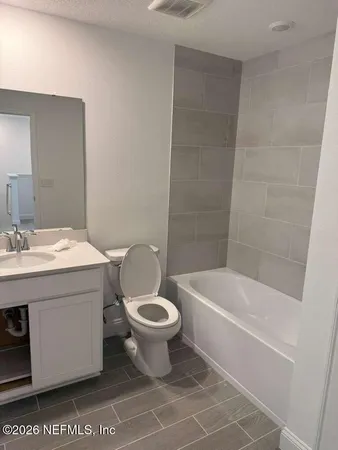 a bathroom with a sink a toilet and bathtub