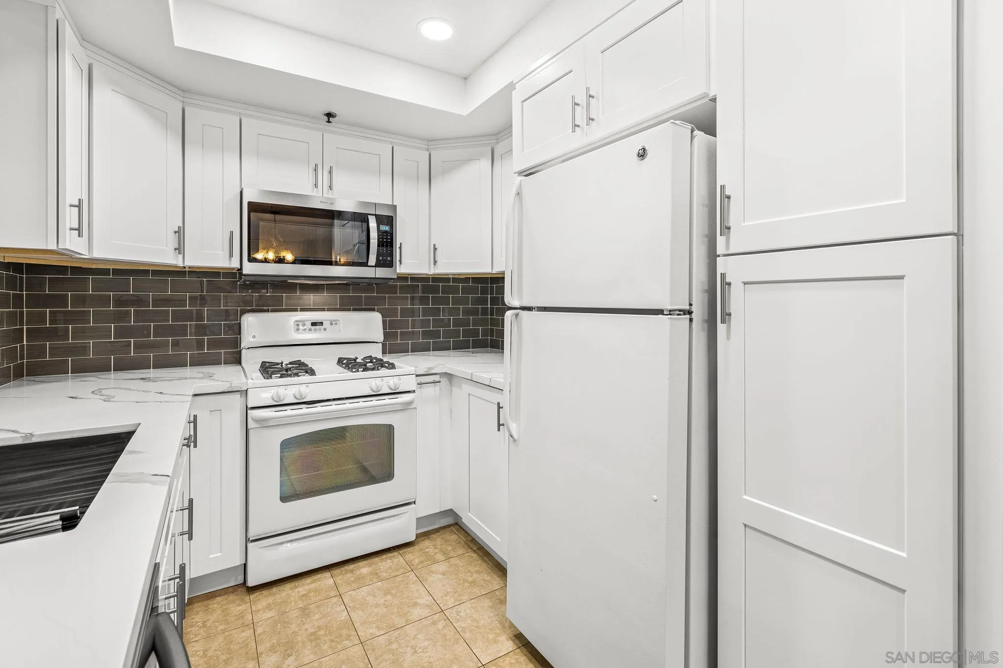 719 Brookstone Road, Unit 203 Chula Vista, CA 91913 - Photo 11 of 23 a white refrigerator freezer sitting in a kitchen