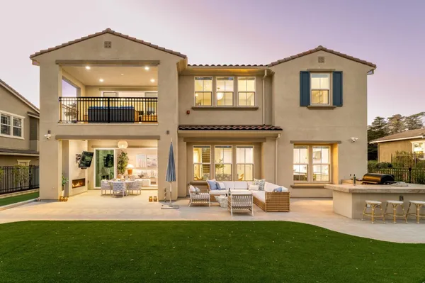 a front view of a house with a yard table and chairs