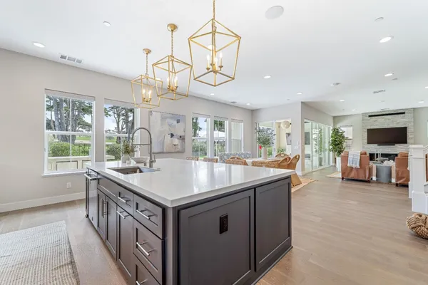 a view of a livingroom with furniture a fireplace and windows