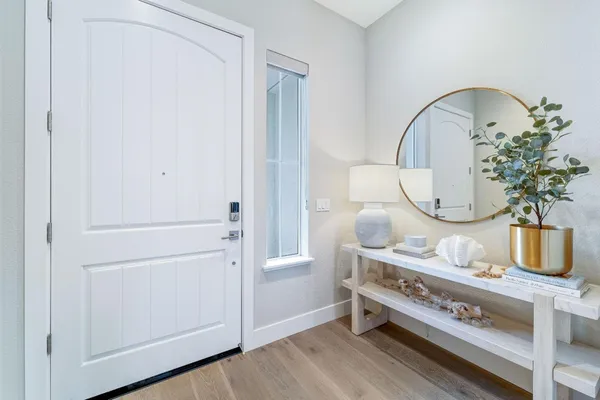 a kitchen with white cabinets and sink