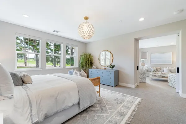 a spacious bathroom with a double vanity sink a mirror and a bathtub