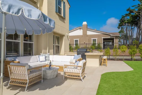 a living room with furniture a fireplace and a floor to ceiling window