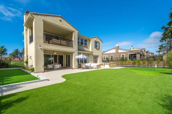 a dining room with furniture and a large window