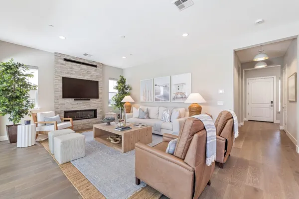 a kitchen with a stove and a view of living room
