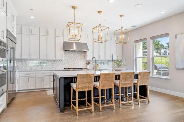 a kitchen with stainless steel appliances a sink stove and refrigerator