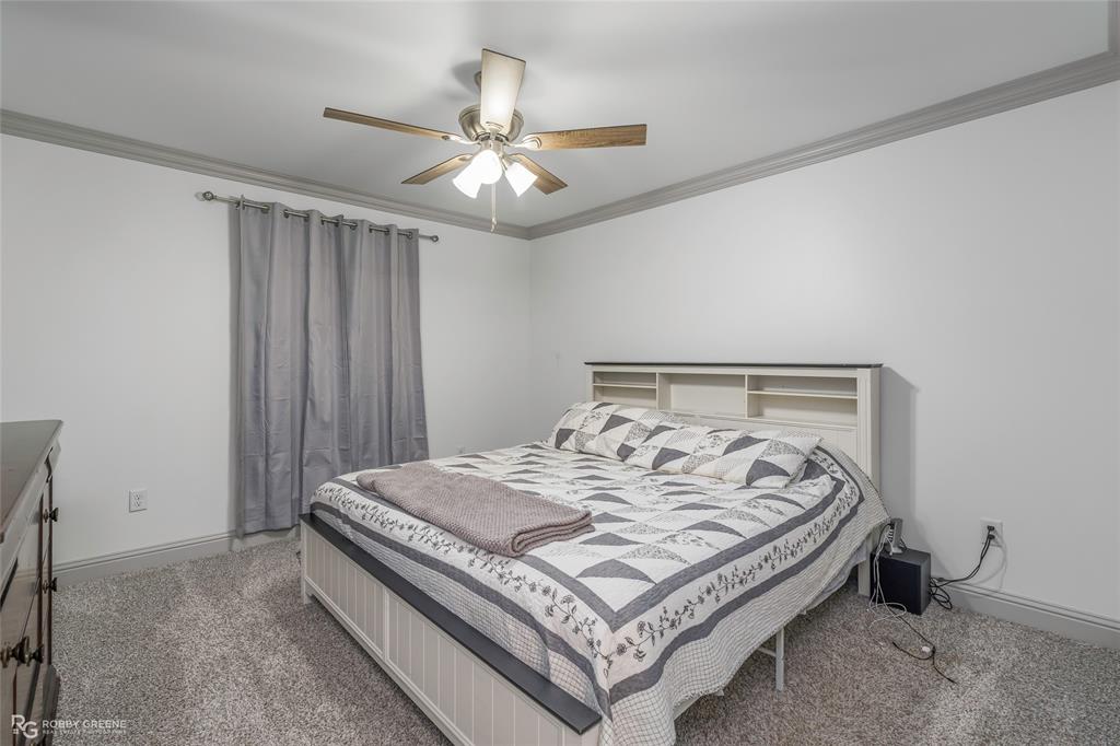 396 Collinswood Road Stonewall, LA 71078 - Photo 20 of 32 a bed sitting in a bedroom and chandelier