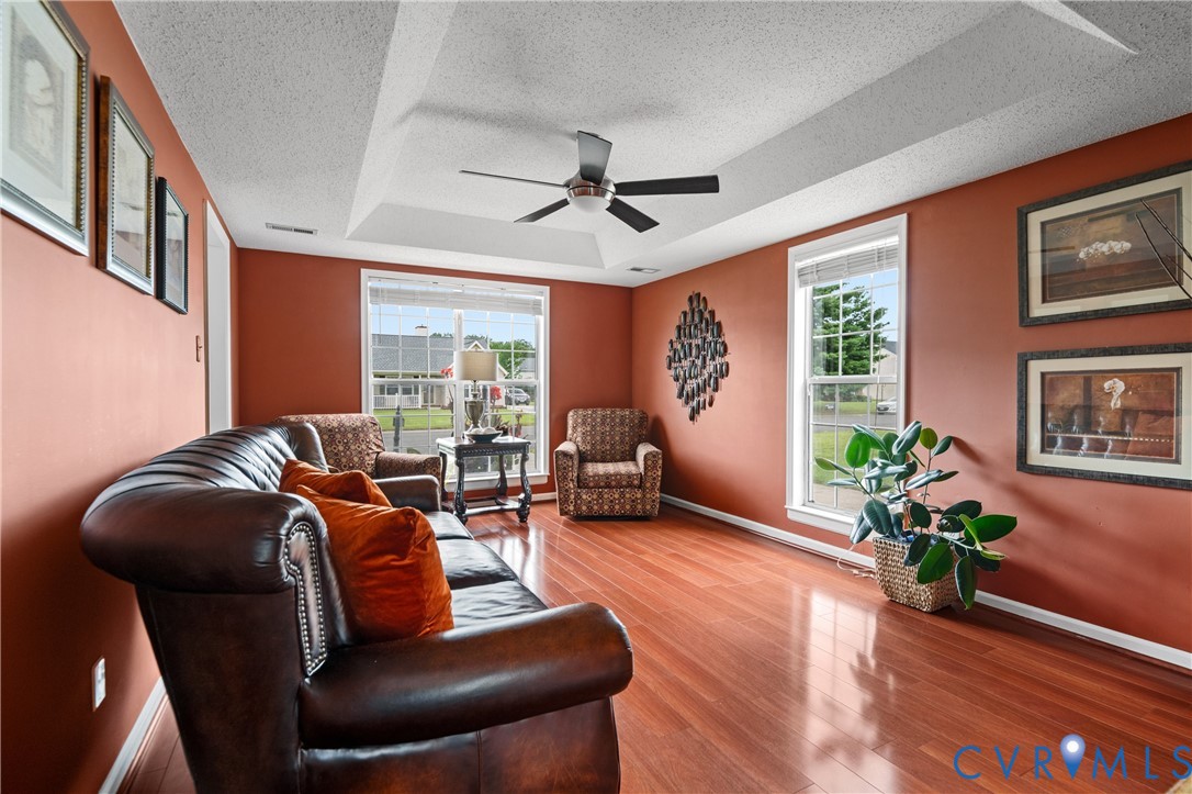 6356 Springcrest Lane Henrico, VA 23231 - Photo 15 of 43 a living room with furniture floor to ceiling window and wooden floor