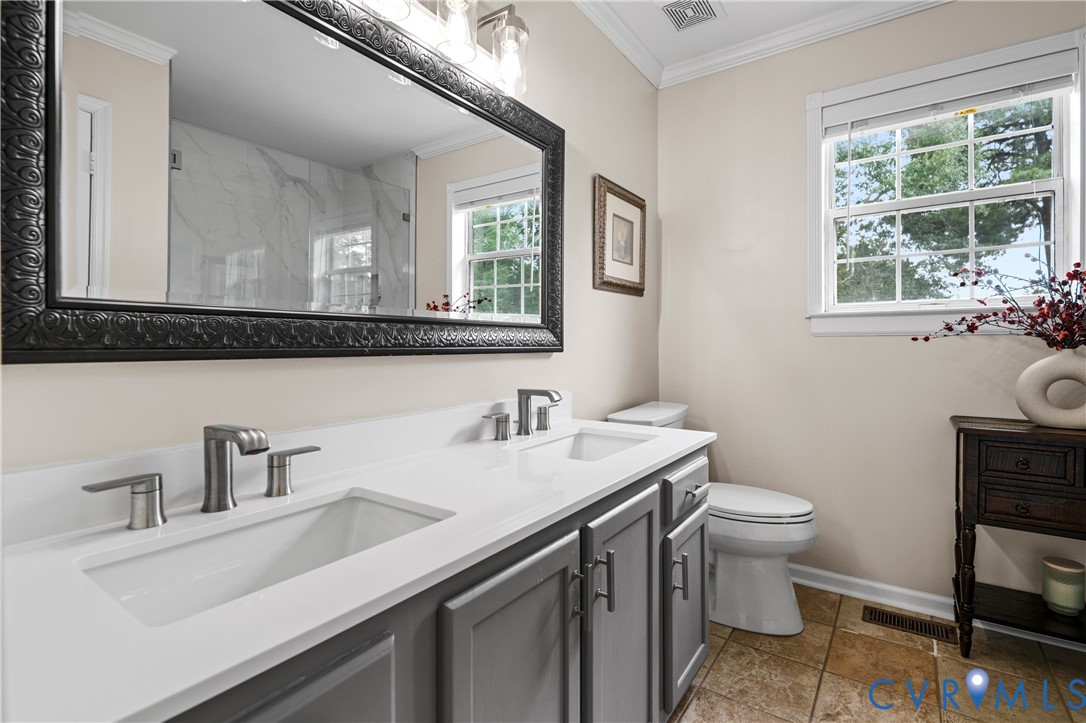 6356 Springcrest Lane Henrico, VA 23231 - Photo 20 of 43 a bathroom with a sink toilet a mirror and window