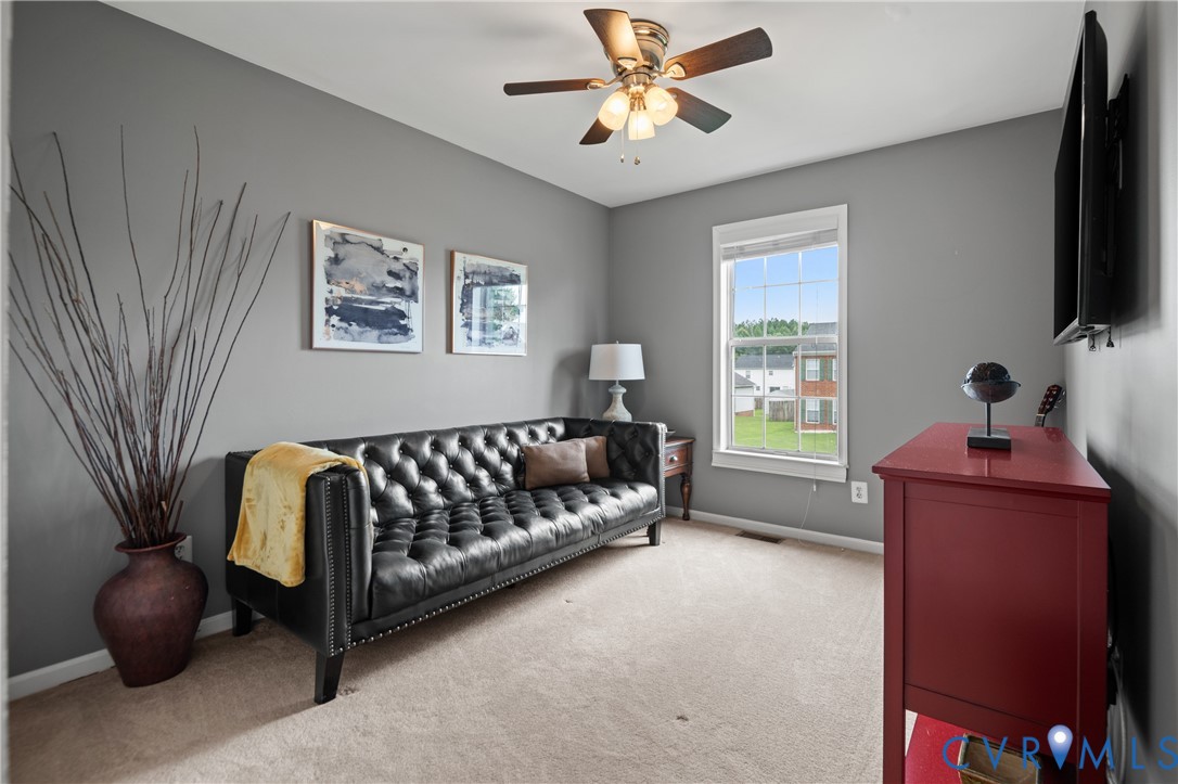 6356 Springcrest Lane Henrico, VA 23231 - Photo 24 of 43 a living room with furniture a flat screen tv and a window
