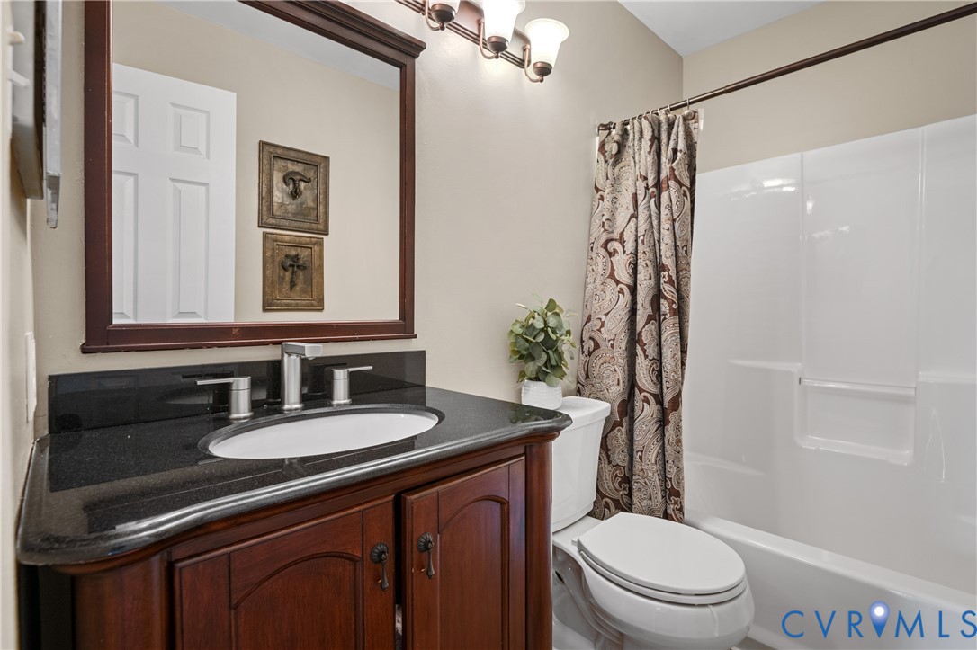 6356 Springcrest Lane Henrico, VA 23231 - Photo 27 of 43 a bathroom with a sink a toilet a mirror and shower
