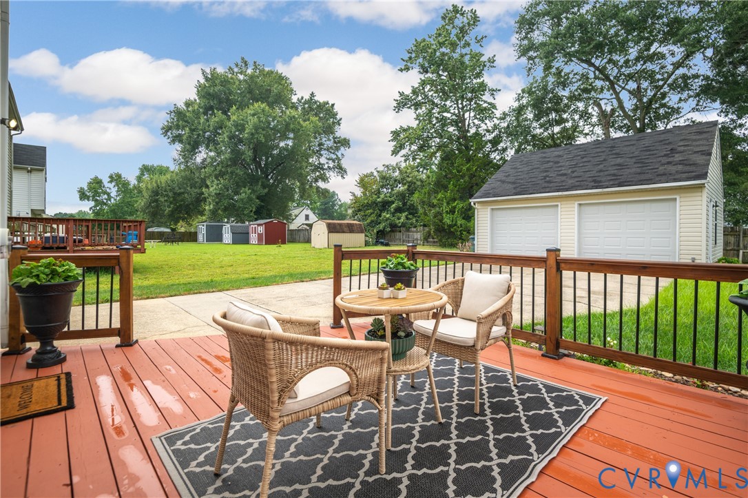 6356 Springcrest Lane Henrico, VA 23231 - Photo 28 of 43 a view of a patio with dining table and chairs with wooden floor and fence